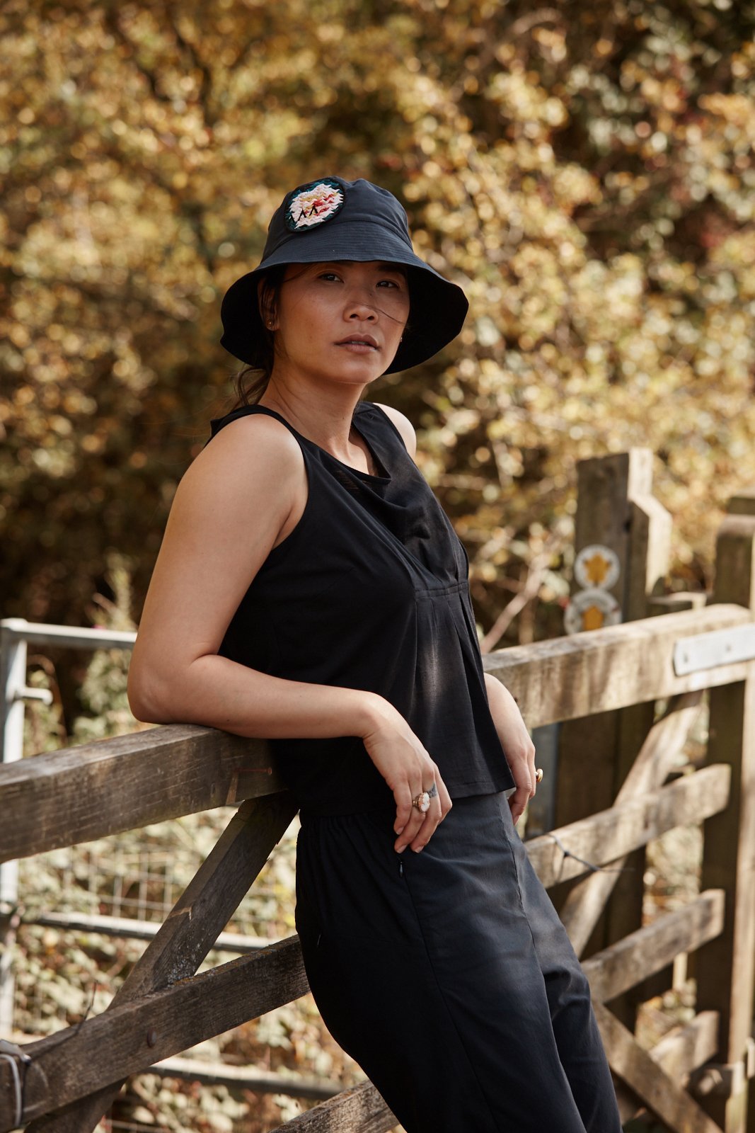 Woman wearing the Asmuss Pleated Tank in Black.  Made in the UK from a luxury wool blended with temperature regulating 37.5 Technology