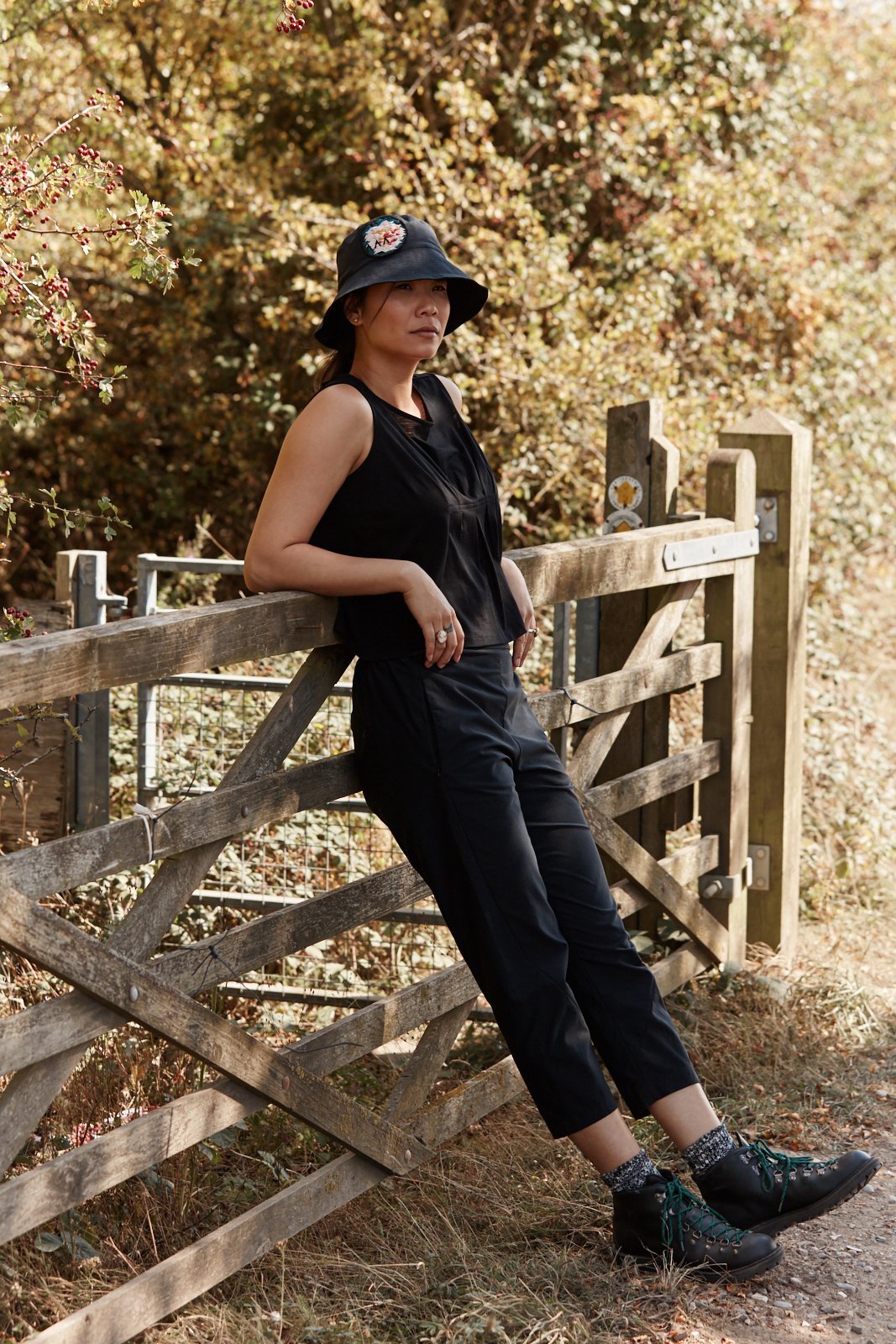 Woman in the countryside wearing the Asmuss Pleated Tank in Black.  Stylish, sustainable performance womenswear for the countryside or city.