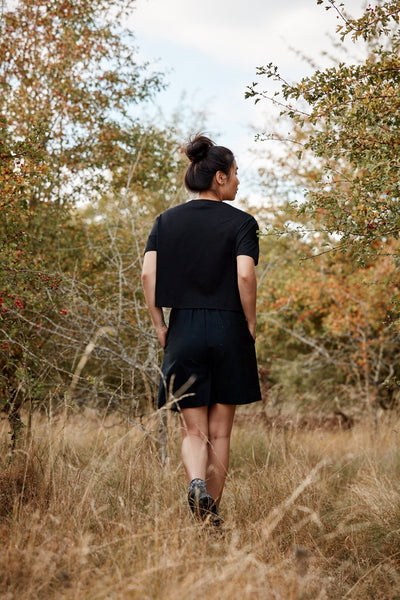 Women walking in the Asmuss Boxy Cropped T-shirt in in Black.  Wear it out hiking or at the gallery
