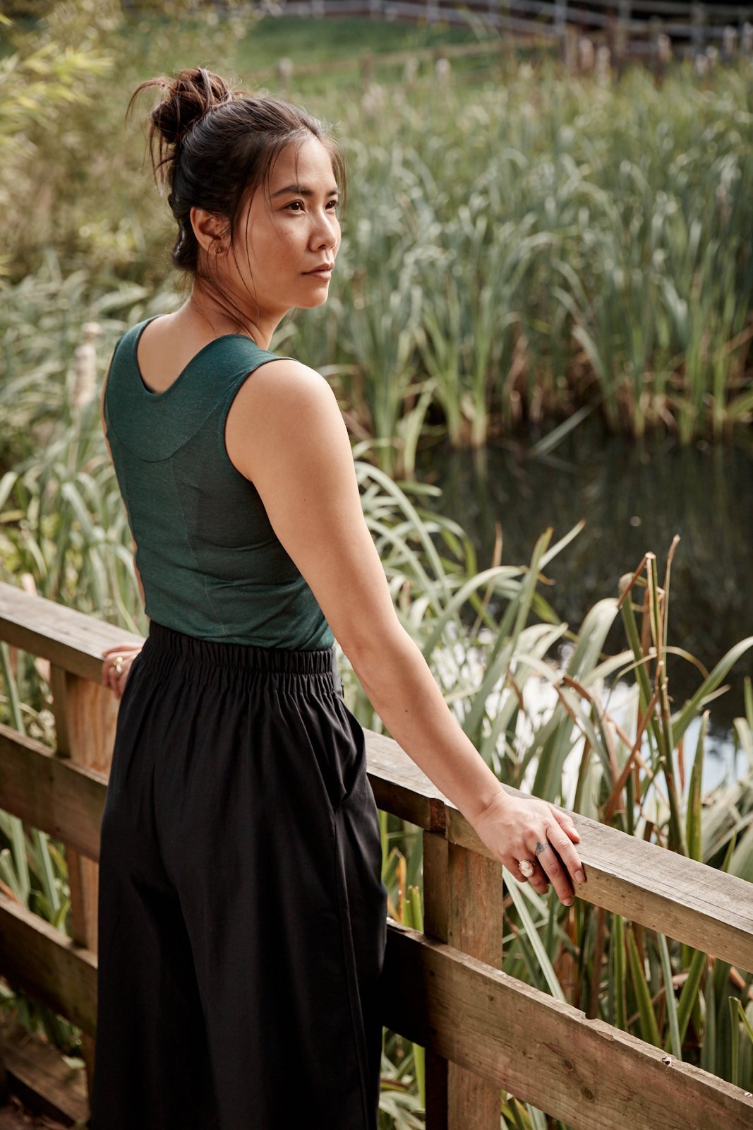 Woman wearing the Asmuss Panelled Tank. Stylish, sustainable, luxury performance womenswear for your travel wardrobe