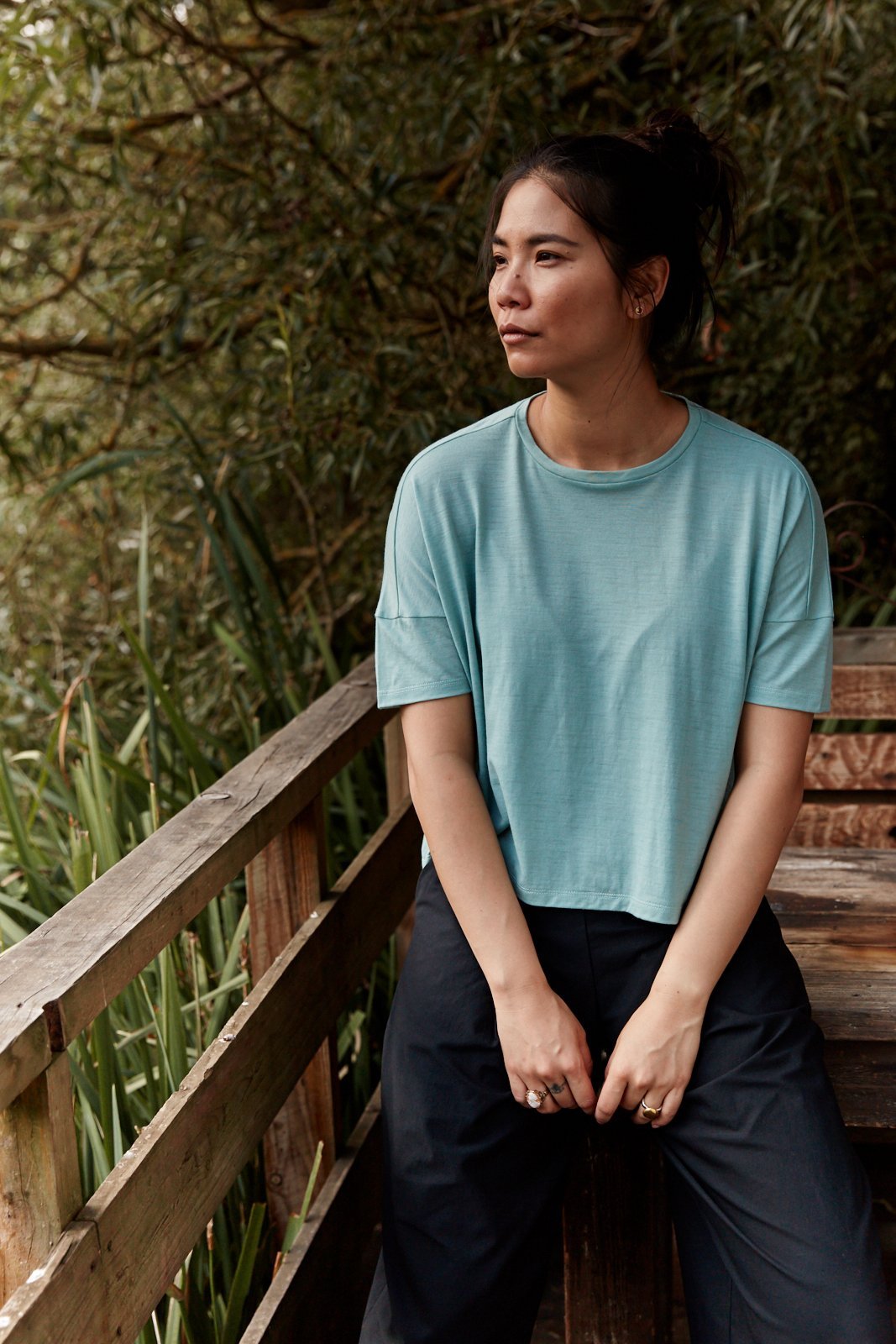 Woman wearing the Asmuss Boxy Cropped T-shirt in Sea Green.  Made in the UK from a blend of wool and 37.5 technology to help keep you at the ideal body temperature