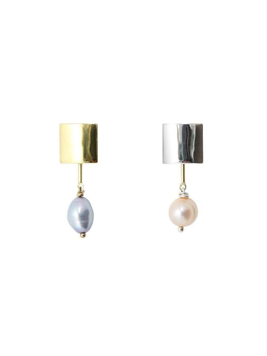 Mismatched earrings with one silver and one gold pearl