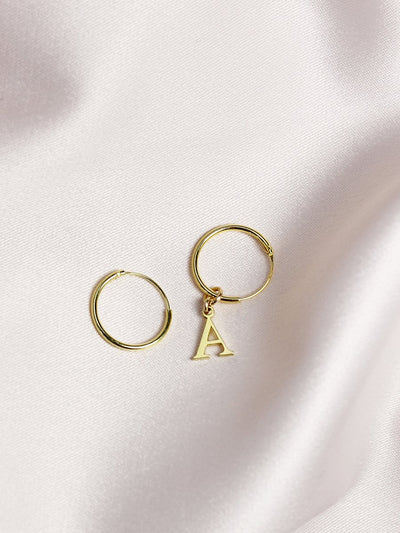 Gold small hoops with letter on one hoop