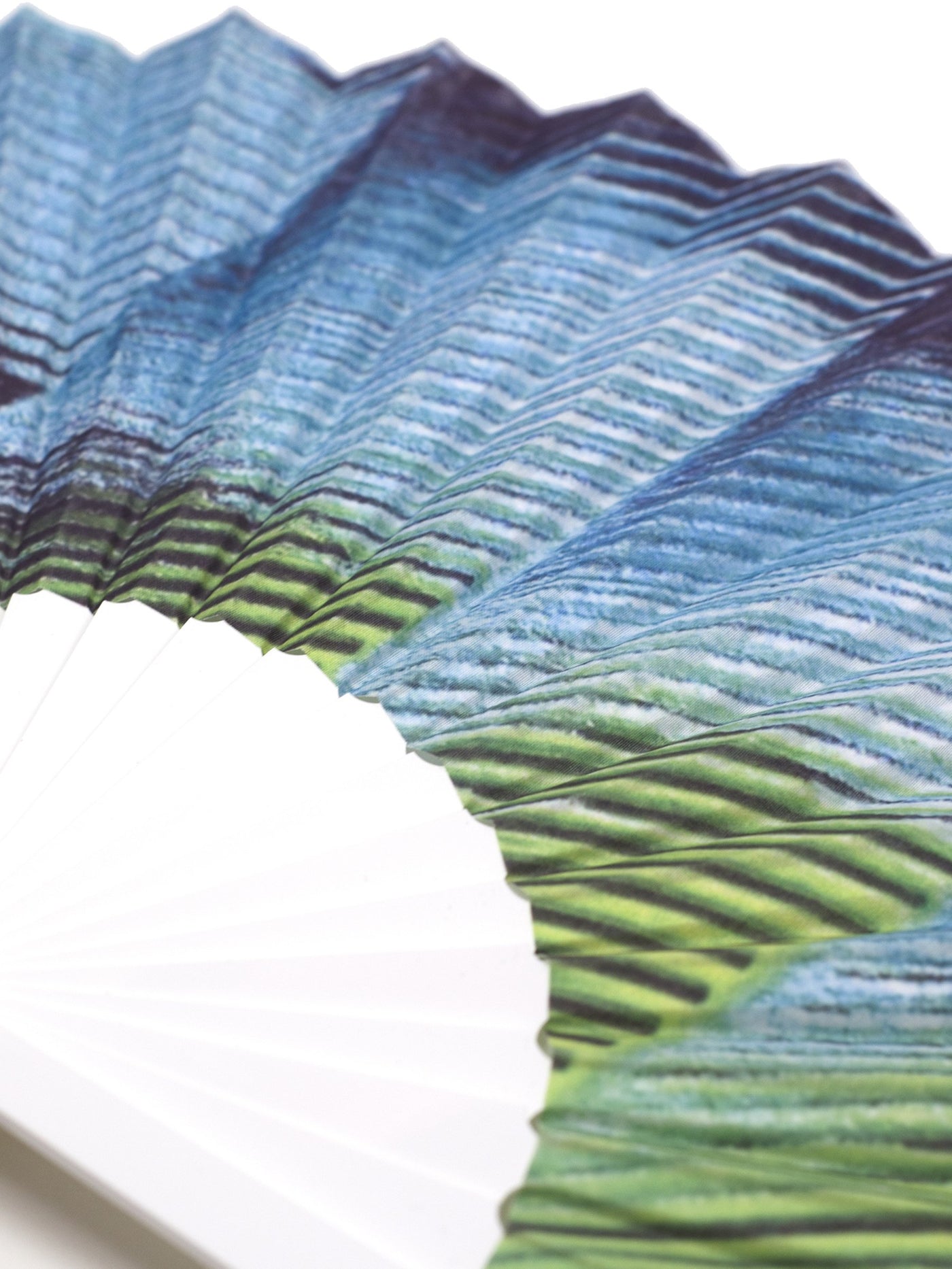 Close Up of Khu Khu MACAW Tropical Bird Wing Print Hand-Fan in blue and green tones. Painted and then printed onto high grade cotton with swiss acrylic bespoke shape white sticks. Blue rivet and white rim. Engraved logo.