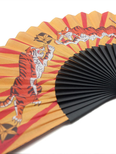 Close up of Tiger Tiger hand-fan from Khu Khu  - 2 symmetrical tigers with red lines like sun rays in background
